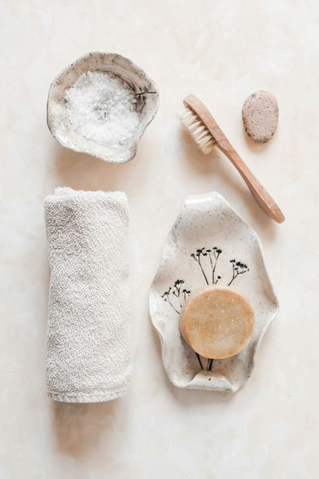 A wooden brush, soap and a cotton towel